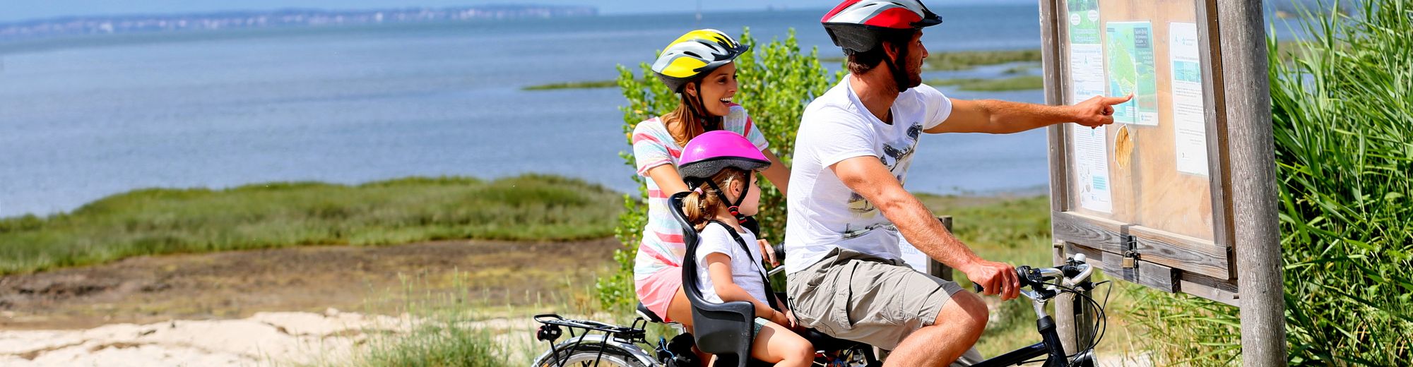 Family of three on a biking day looking at map | © goodluz - stock.adobe.com