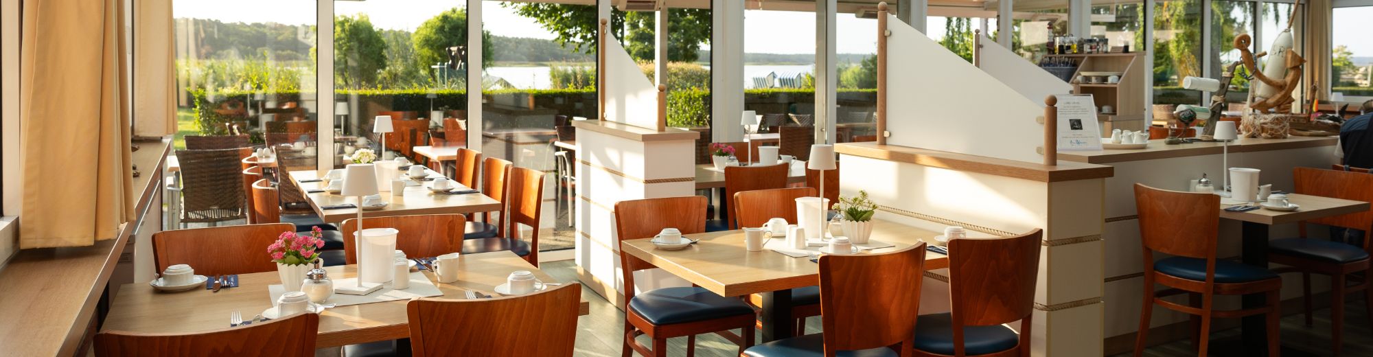 Wintergarten eines Restaurants mit eingedeckten Tischen