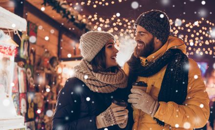 Having fun together at a christmas fairy with snowfall...: | © deagreez - stock.adobe.com
